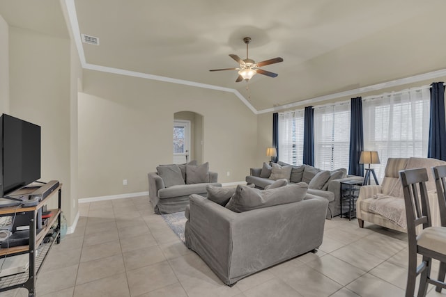 living room with ornamental molding, arched walkways, a ceiling fan, and plenty of natural light