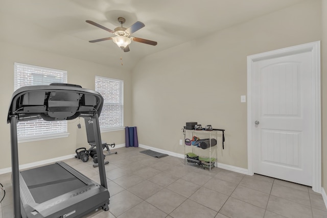 exercise room with a ceiling fan, baseboards, and light tile patterned flooring