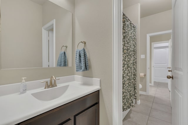 bathroom with a shower with shower curtain, tile patterned flooring, and vanity