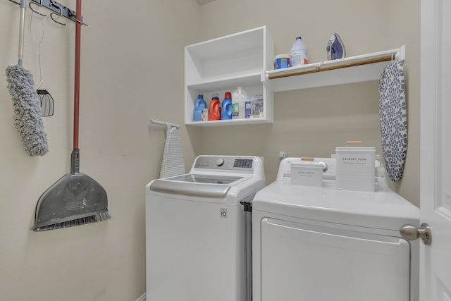 washroom featuring separate washer and dryer and laundry area