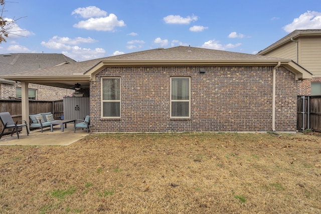 back of house with a lawn, a fenced backyard, a patio area, roof with shingles, and brick siding