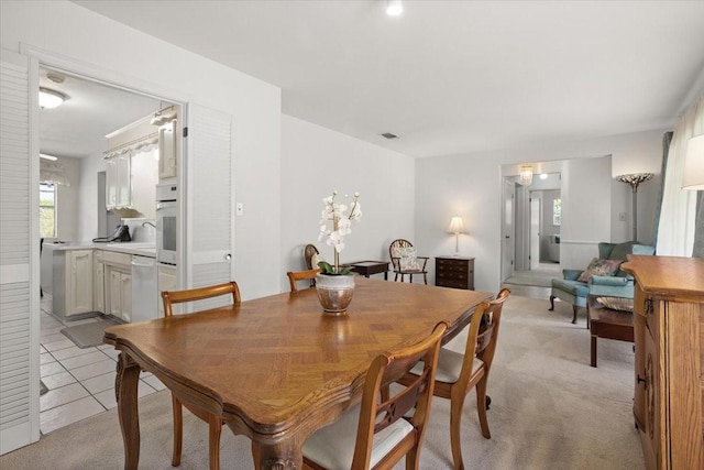 dining area featuring light colored carpet