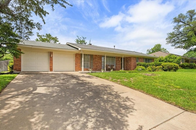 ranch-style home with a front lawn, driveway, brick siding, and a garage