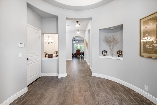 4037 Knightsbridge Ln, Midlothian, TX 76065 - hallway with arched walkways, baseboards, a chandelier, and dark wood-style floors