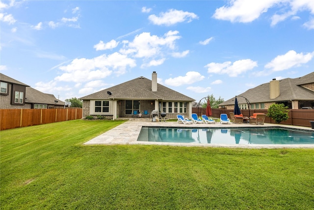 4037 Knightsbridge Ln, Midlothian, TX 76065 - back of house with a yard, a patio, a fenced backyard, a fenced in pool, and a chimney