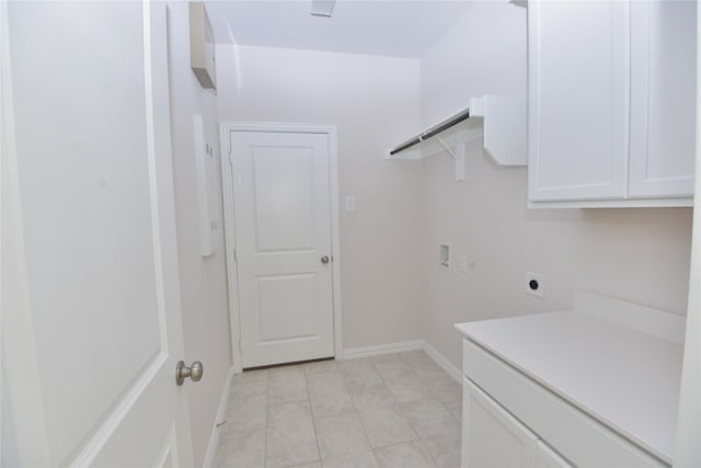 925 Plaza Ln, Argyle, TX 76226 - laundry area featuring cabinet space, hookup for an electric dryer, light tile patterned flooring, baseboards, and hookup for a washing machine