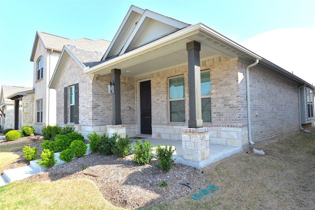 925 Plaza Ln, Argyle, TX 76226 - view of front of house with roof with shingles, a porch, and brick siding