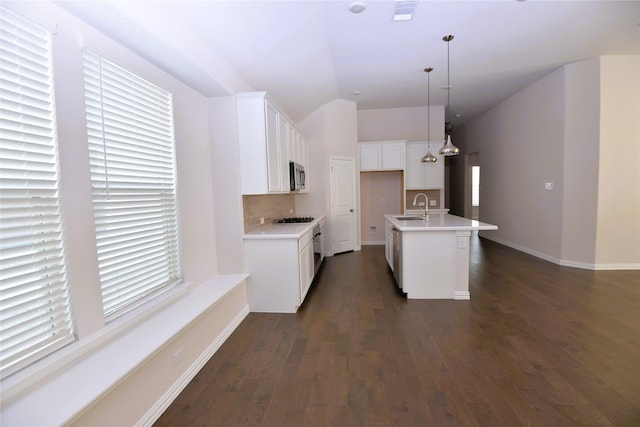 925 Plaza Ln, Argyle, TX 76226 - kitchen with stainless steel microwave, a sink, backsplash, gas stovetop, and dark wood-style floors