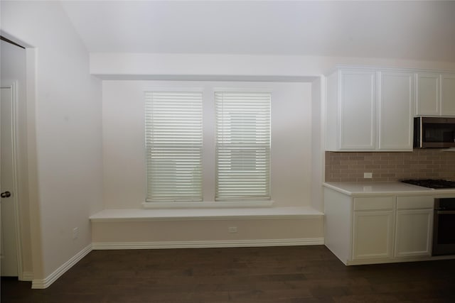 925 Plaza Ln, Argyle, TX 76226 - kitchen featuring white cabinetry, dark wood-style flooring, light countertops, appliances with stainless steel finishes, and tasteful backsplash
