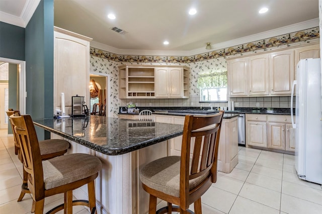 6200 Forest River Dr, Fort Worth, TX 76112 - kitchen with a peninsula, a breakfast bar area, freestanding refrigerator, open shelves, and crown molding