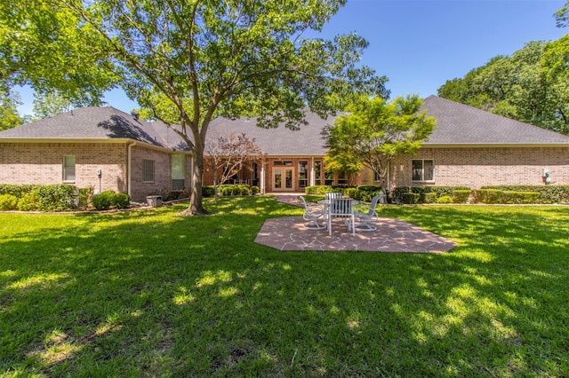 6200 Forest River Dr, Fort Worth, TX 76112 - rear view of property with a yard, a patio area, brick siding, and french doors