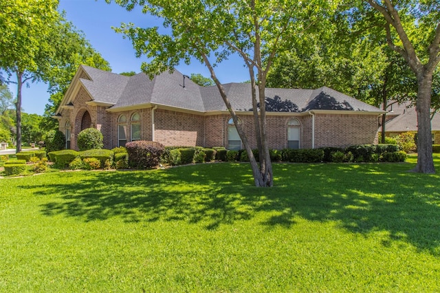 6200 Forest River Dr, Fort Worth, TX 76112 - view of side of property featuring a shingled roof, brick siding, and a lawn