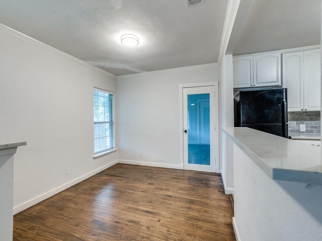3703 Clover Ln, Dallas, TX 75220 - unfurnished living room with baseboards, ornamental molding, a textured ceiling, and dark wood-type flooring