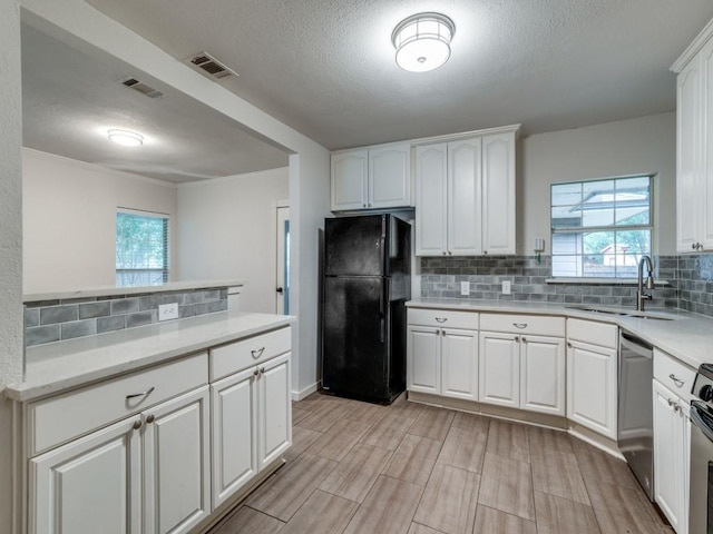 3703 Clover Ln, Dallas, TX 75220 - kitchen with a textured ceiling, visible vents, appliances with stainless steel finishes, and a sink