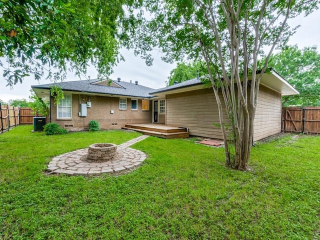3703 Clover Ln, Dallas, TX 75220 - back of house with a fenced backyard, a wooden deck, a fire pit, and central air condition unit