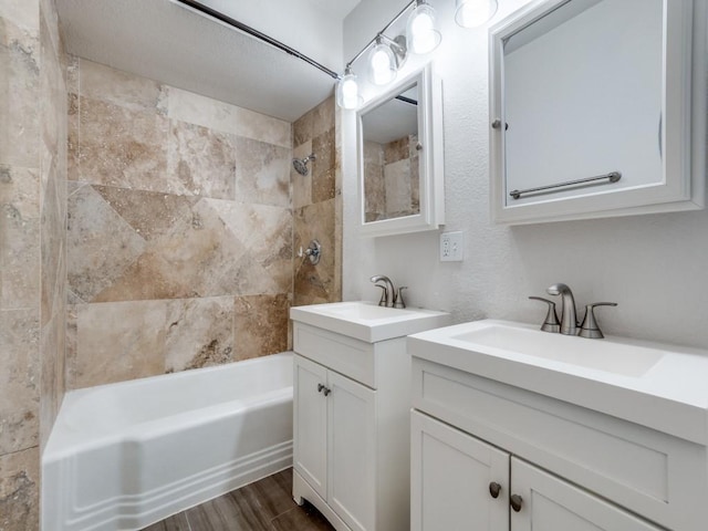 3703 Clover Ln, Dallas, TX 75220 - full bath with a sink, tub / shower combination, two vanities, and wood finished floors