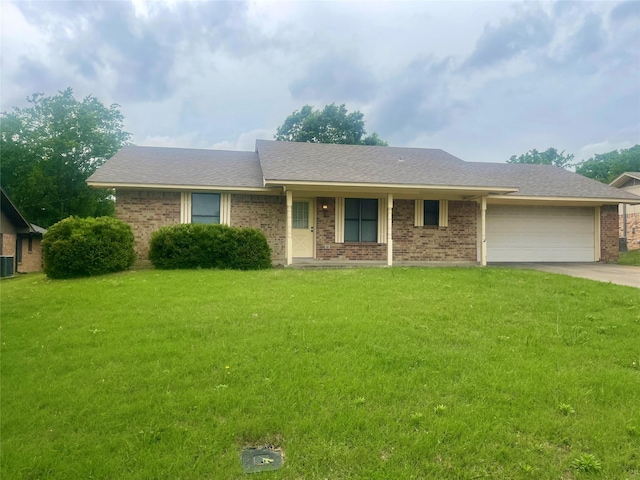 ranch-style home with a front lawn, brick siding, driveway, and a garage