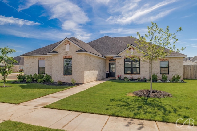 7001 Breezeway Dr, Abilene, TX 79606 - view of front of house featuring roof with shingles, brick siding, and a front lawn