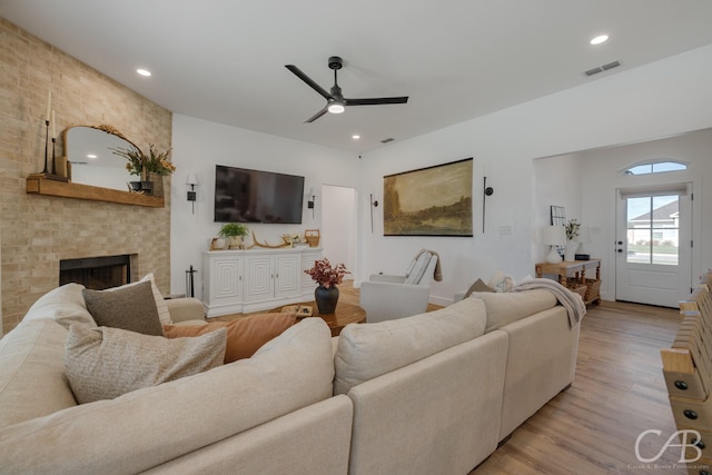 7001 Breezeway Dr, Abilene, TX 79606 - living room featuring visible vents, recessed lighting, a fireplace, ceiling fan, and light wood finished floors