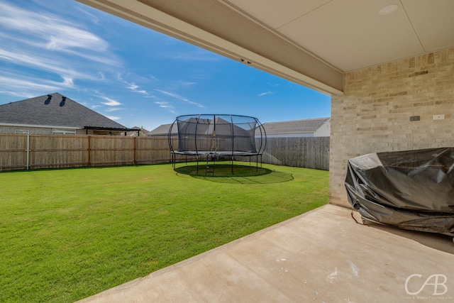 7001 Breezeway Dr, Abilene, TX 79606 - view of yard with a trampoline, a patio area, and a fenced backyard