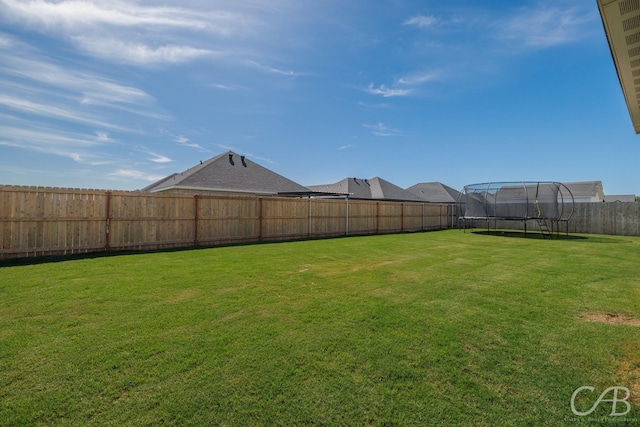 7001 Breezeway Dr, Abilene, TX 79606 - view of yard featuring a trampoline and a fenced backyard