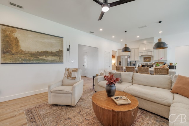 7001 Breezeway Dr, Abilene, TX 79606 - living room with light wood finished floors, ceiling fan, visible vents, and recessed lighting