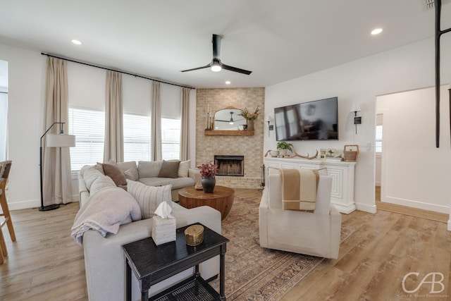 7001 Breezeway Dr, Abilene, TX 79606 - living room with a ceiling fan, a brick fireplace, light wood-type flooring, baseboards, and recessed lighting