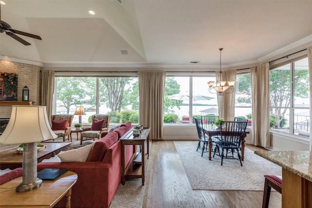 living room with healthy amount of natural light, light wood-style floors, and ornamental molding