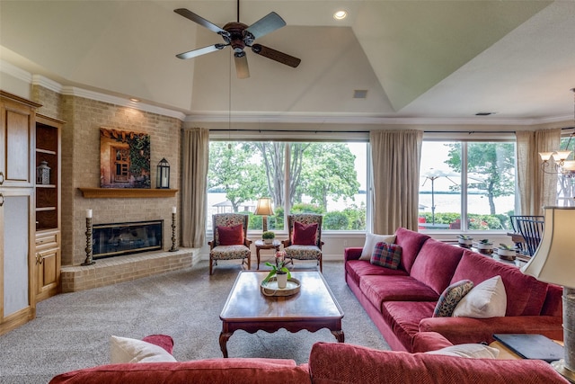 living area with ceiling fan, carpet, a brick fireplace, lofted ceiling, and crown molding