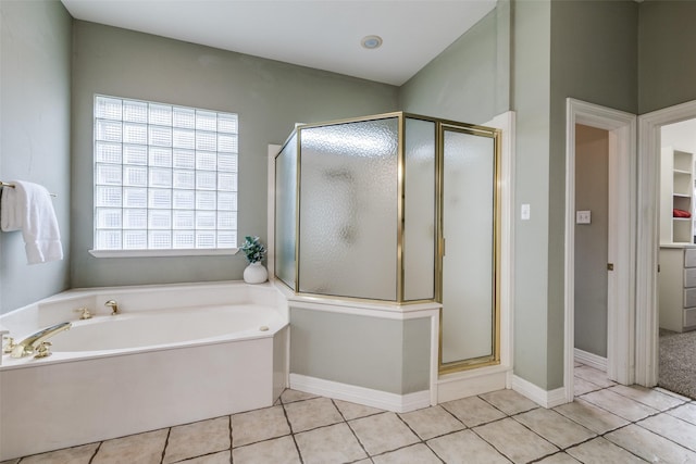 full bathroom featuring a shower stall, a garden tub, tile patterned floors, a spacious closet, and baseboards