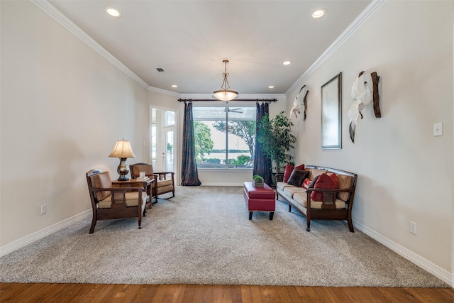 sitting room featuring baseboards, recessed lighting, crown molding, and wood finished floors