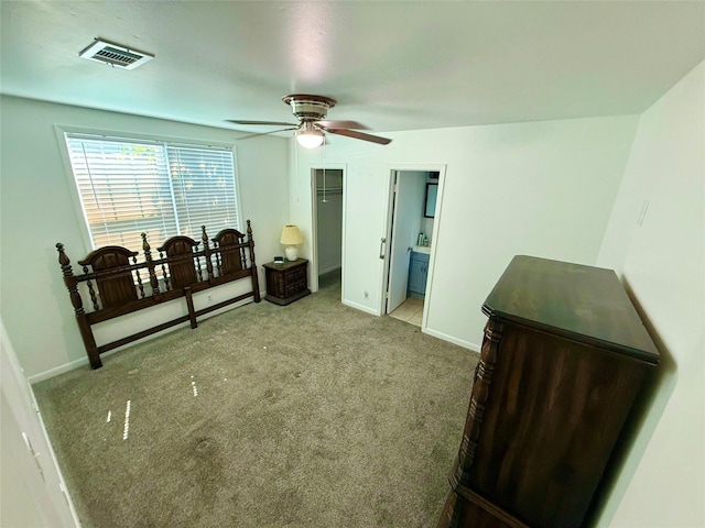 carpeted bedroom with a closet, visible vents, a ceiling fan, connected bathroom, and baseboards