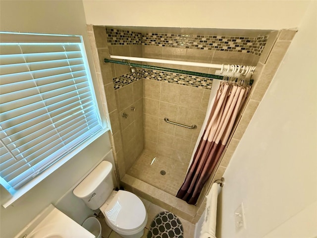 full bath with a stall shower and toilet