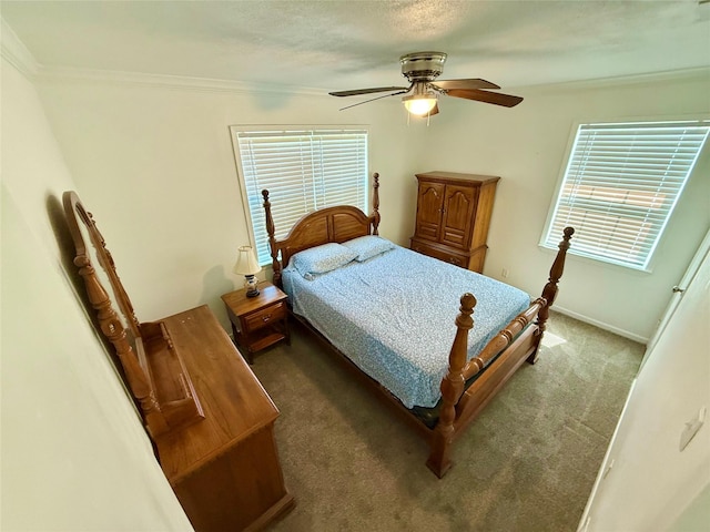 carpeted bedroom with ceiling fan, ornamental molding, and baseboards