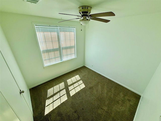 empty room with visible vents, baseboards, a ceiling fan, and carpet floors