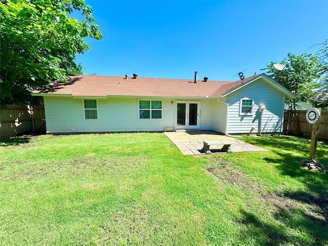 back of property featuring a patio, french doors, a lawn, and a fenced backyard