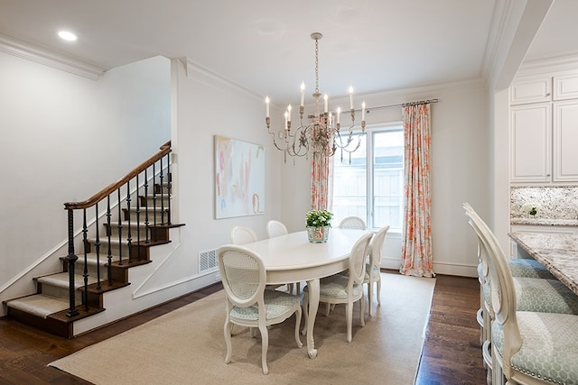 dining area with a chandelier, ornamental molding, stairs, and wood finished floors