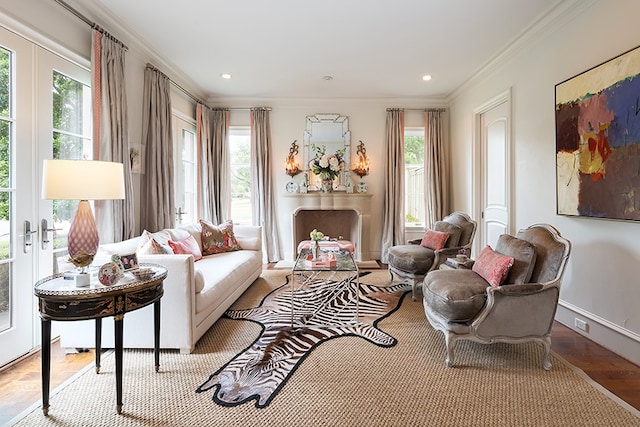 living area with wood finished floors, baseboards, ornamental molding, and recessed lighting