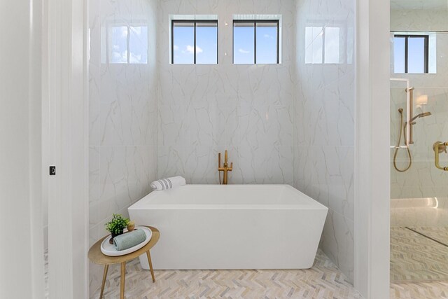 13696 Declan St, Frisco, TX 75033 - bathroom featuring tile walls, a soaking tub, and a shower