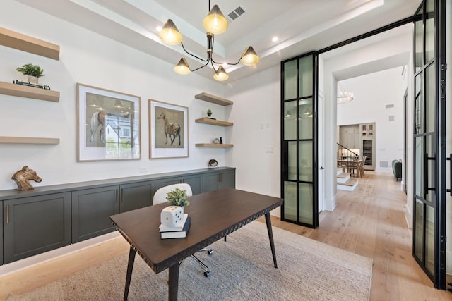 13696 Declan St, Frisco, TX 75033 - home office featuring a chandelier, light wood-style flooring, a tray ceiling, and recessed lighting