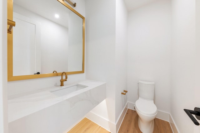 13696 Declan St, Frisco, TX 75033 - bathroom with wood finished floors, toilet, baseboards, and vanity
