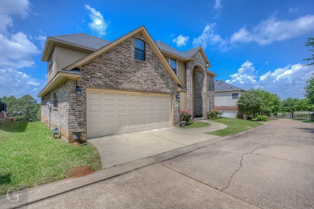 view of front facade featuring fence, an attached garage, brick siding, concrete driveway, and a front lawn