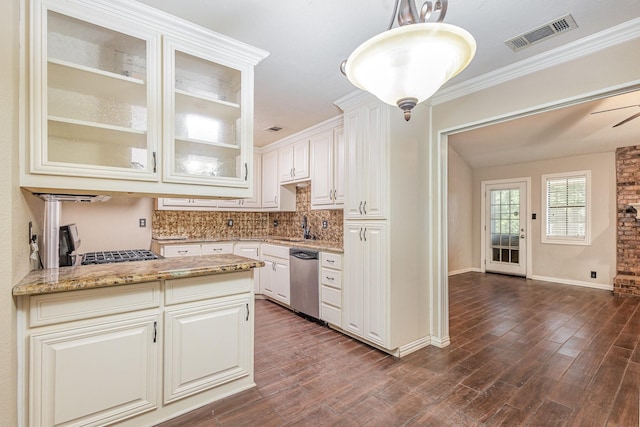 122 Big Bend Blvd, Waxahachie, TX 75165 - kitchen featuring appliances with stainless steel finishes, decorative backsplash, dark wood-style flooring, white cabinets, and light stone countertops