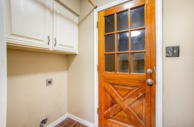 122 Big Bend Blvd, Waxahachie, TX 75165 - laundry area featuring cabinet space, electric dryer hookup, baseboards, and dark wood-type flooring