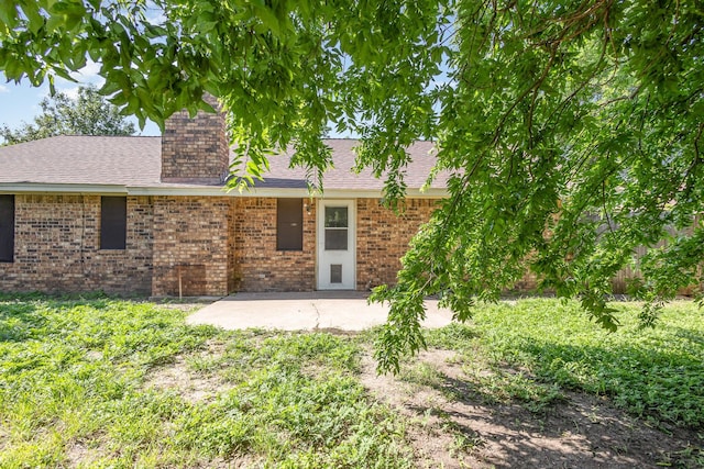 122 Big Bend Blvd, Waxahachie, TX 75165 - back of property featuring a patio area, brick siding, and roof with shingles