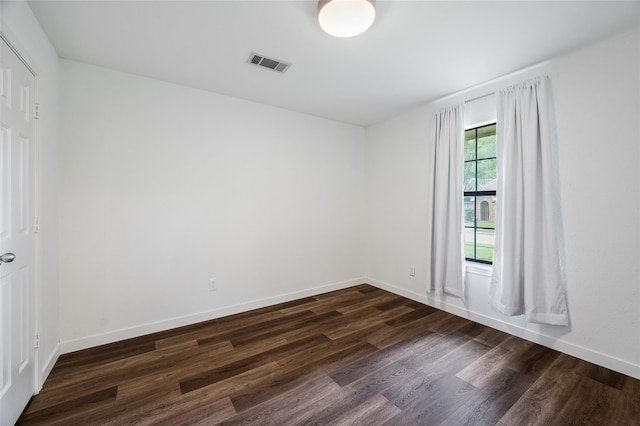 1413 Pecan Creek Dr, Garland, TX 75044 - empty room featuring dark wood-style flooring, baseboards, and visible vents