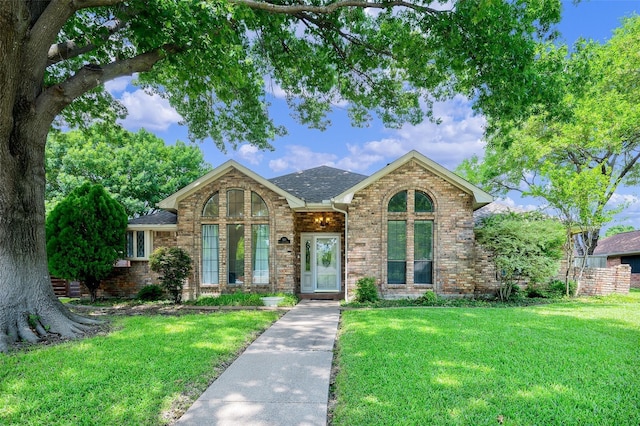 1413 Pecan Creek Dr, Garland, TX 75044 - view of front of property featuring a front lawn, brick siding, and roof with shingles