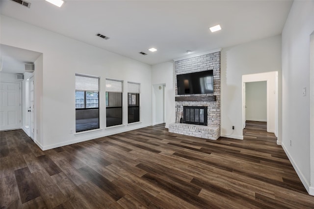 1413 Pecan Creek Dr, Garland, TX 75044 - unfurnished living room featuring baseboards, a brick fireplace, dark wood finished floors, and visible vents