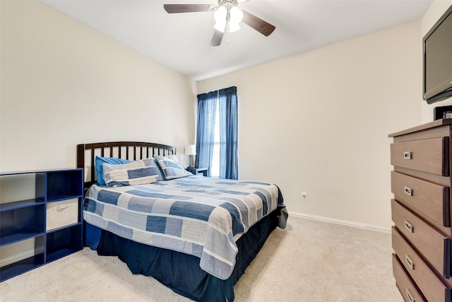 bedroom with light colored carpet, baseboards, and ceiling fan