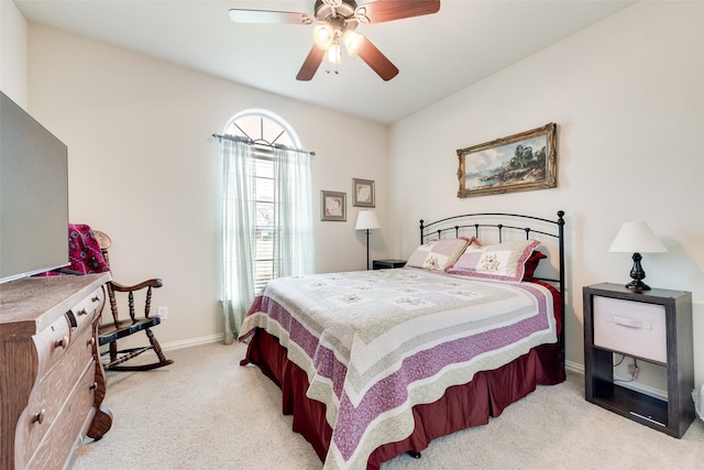 bedroom featuring light carpet, baseboards, and ceiling fan
